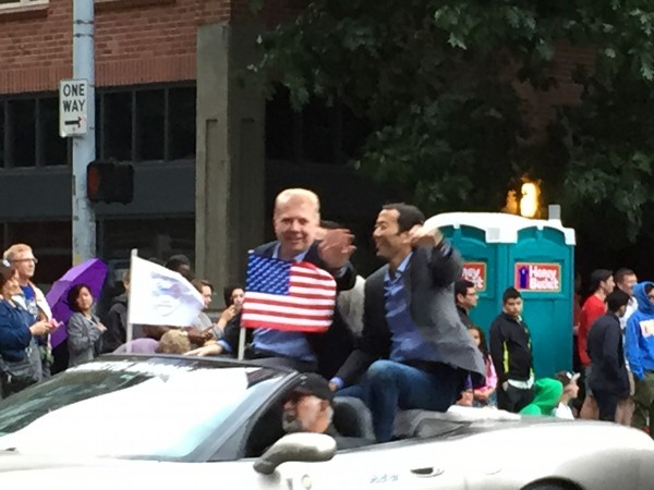 Mayor Ed Murray (left) and husband Michael Shiosaki (right) participating in the Seafair Torchlight Parade